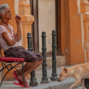 Lady smoking while seated on a chair