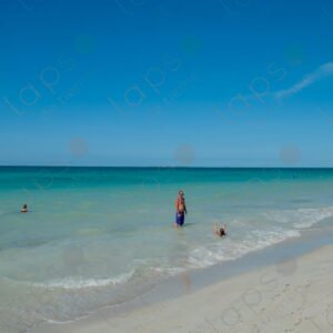 Man and his daughter bathing in the turquoise sea
