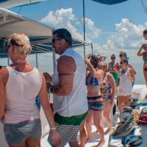 Party on a yacht, with crew and tourists