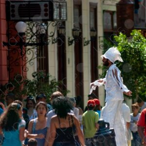 People on the street, man on stilts