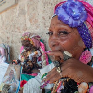 Portrait of a Cuban lady's face and nails with a cigar (habano)