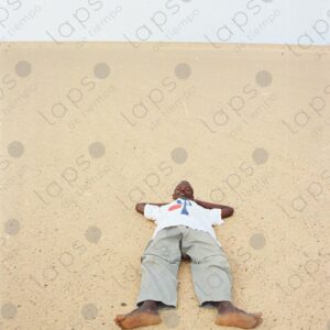 Man lying in the sand of the Western Sahara desert