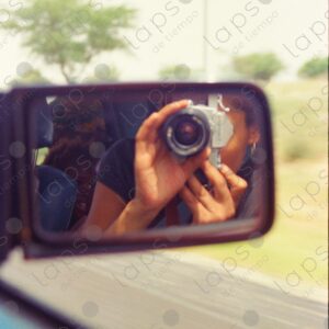 Reflection of the photographer with an old camera in the rearview mirror 1