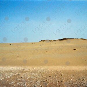 Western Sahara Desert, cars and people in the distance