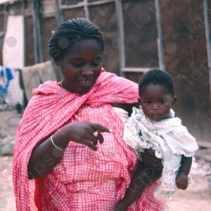 Woman Dressed in Islamic Clothing with Baby in Her Arms