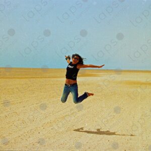 Woman jumping in the Western Sahara desert