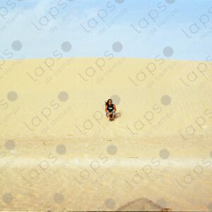 Woman sitting on a dune in Western Sahara 2