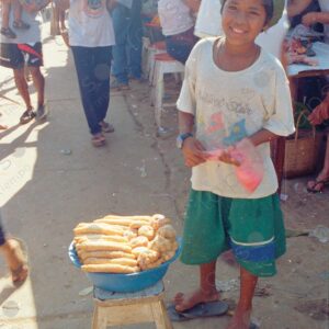 A teenager at the Requena Market sells churros