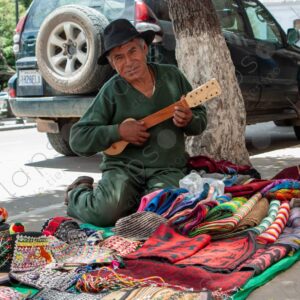 Bolivian Man with Charango Ambulant Seller of Textiles 2