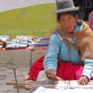 Bolivian lady weaving on her loom 2