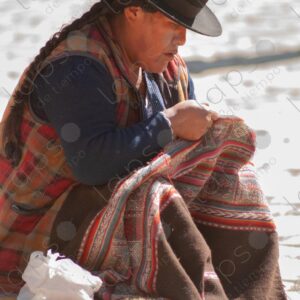 Bolivian woman arranging an awayo