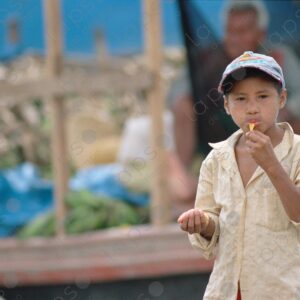 Boy eats dried banana