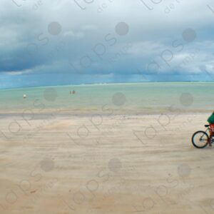 Boy riding a bicycle in the sand turquoise sea 4