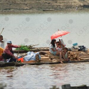 Canoe loaded with firewood with family