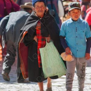 Child and woman in traditional attire Tarabuco Market Bolivia.