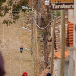 Cobblestone Street Slope Elderly Bolivian Woman Climbing in the Distance 1