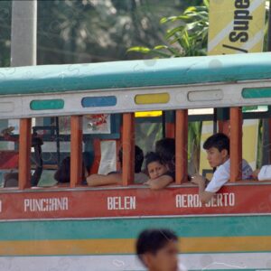 Detail of a bus with passengers looking out the windows