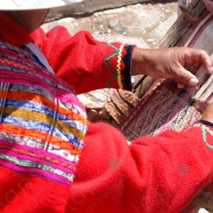 Detail of a woman weaving on a loom