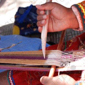 Detail of hands with bone weaving on a loom 2