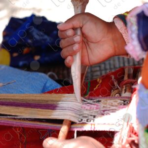 Detail of hands with bone weaving on a loom 3