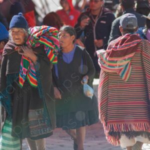Elderly woman in traditional attire and man in traditional poncho Tarabuco Bolivia 1