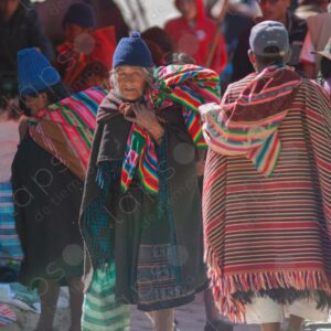 Elderly woman in traditional attire and man in traditional poncho Tarabuco Bolivia 2
