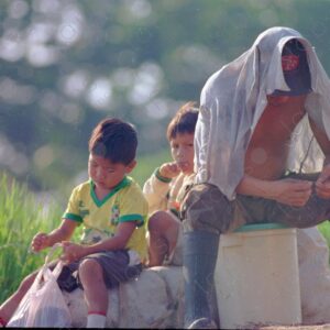 Father and children at the port waiting for transport