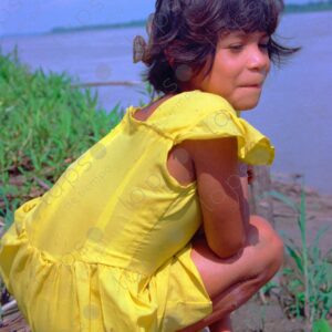 Girl in a yellow dress on the riverbank 2