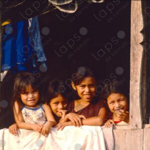 Group of girls at the window of the wooden house 1