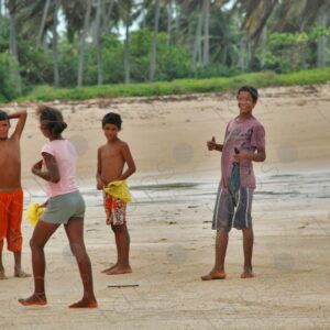 Group of teenagers standing on sand looking at camera 1