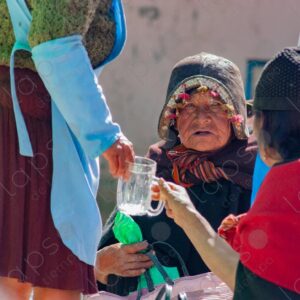 Indigenous man with a traditional hat conversing in Tarabuco 1