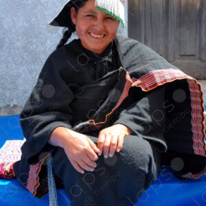 Indigenous woman dressed in black and decorated hat 1