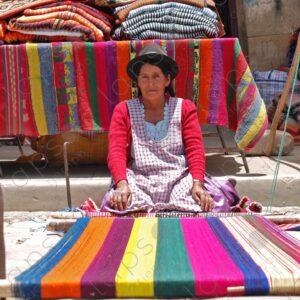 Indigenous woman on the ground shows her loom 1