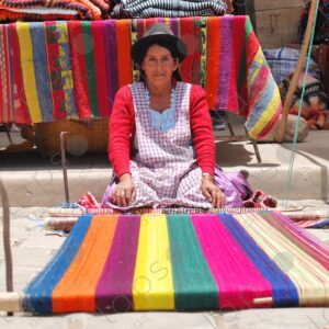 Indigenous woman on the ground shows her loom 2
