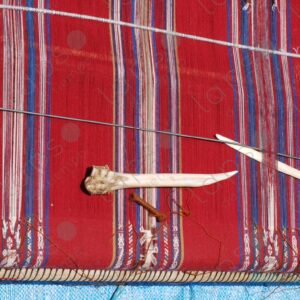 Lama bones on red loom