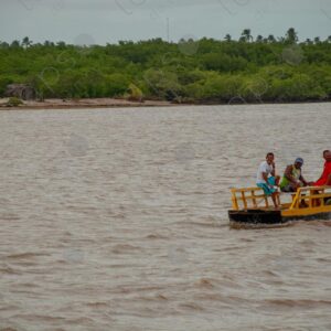 Landscape of a river with three men in a barge