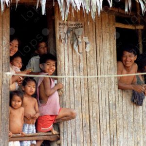 Large family looking out from a small wooden house 1