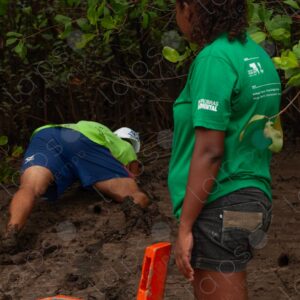 Man in the mud looking for crabs