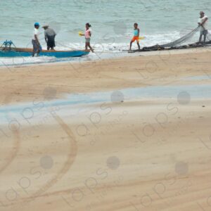 Men with boats and nets on the seashore