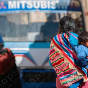 Mother carrying child on her back