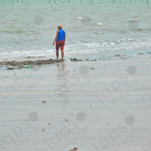 Sea shore child plays mother near
