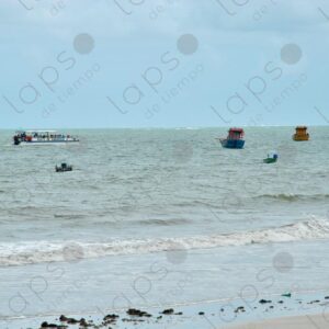 Several artisanal fishing boats in sea seen from the beach 2