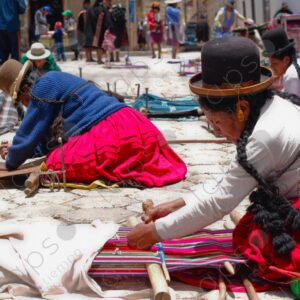 Several weavers on the floor with their looms weaving 2