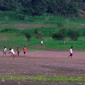 The children play soccer in the field