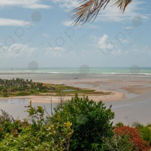 The mouth of the river with brown and turquoise sea