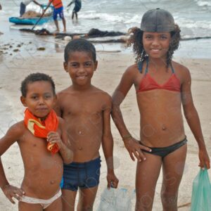 Three brothers in swimsuits posing for the camera on the seashore 3