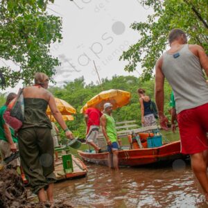 Tourists boarding a small boat on the river 2