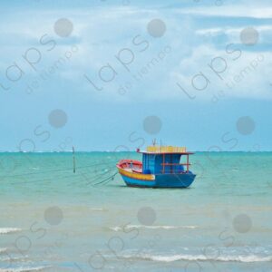 Turquoise sea a small blue artisanal fishing boat floating