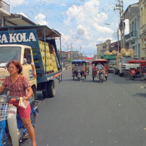 Woman with motorcycle and Inka Kola truck