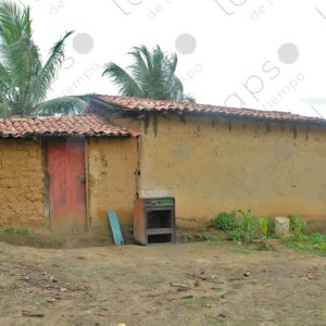 Yellow painted adobe house with tile roof 1